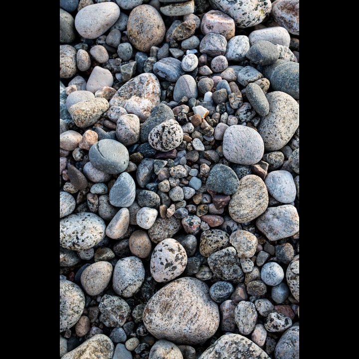 Stones and pebbles at Østhasselstrand. These were brought by the last Ice Age glacier, then ground and polished by the waves.