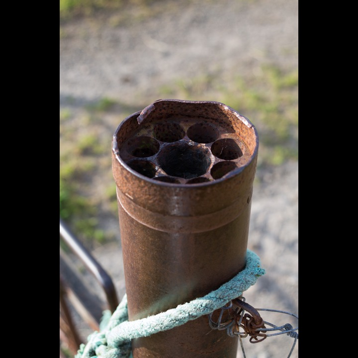 A gatepost at Østhasselstrand made from some sort of WWII munitions