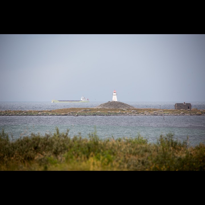 Rauna, a remnant of the last ice age, with lighthouse on burial mound, and a stone cabin shelter for the shipwrecked