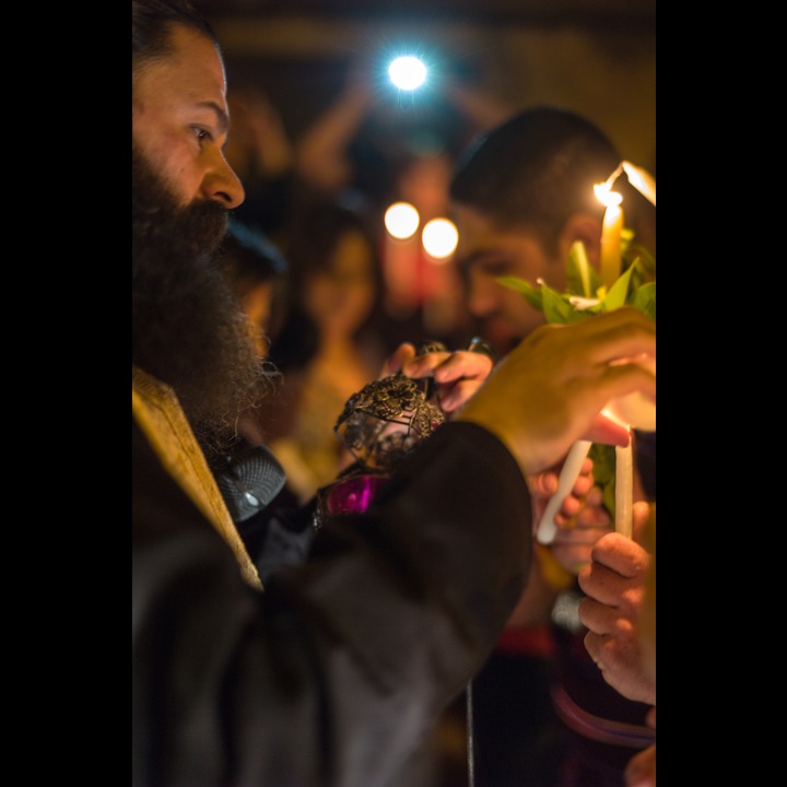 The Greek Orthodox pastor of Marjaayoun relighting his copy of the flame