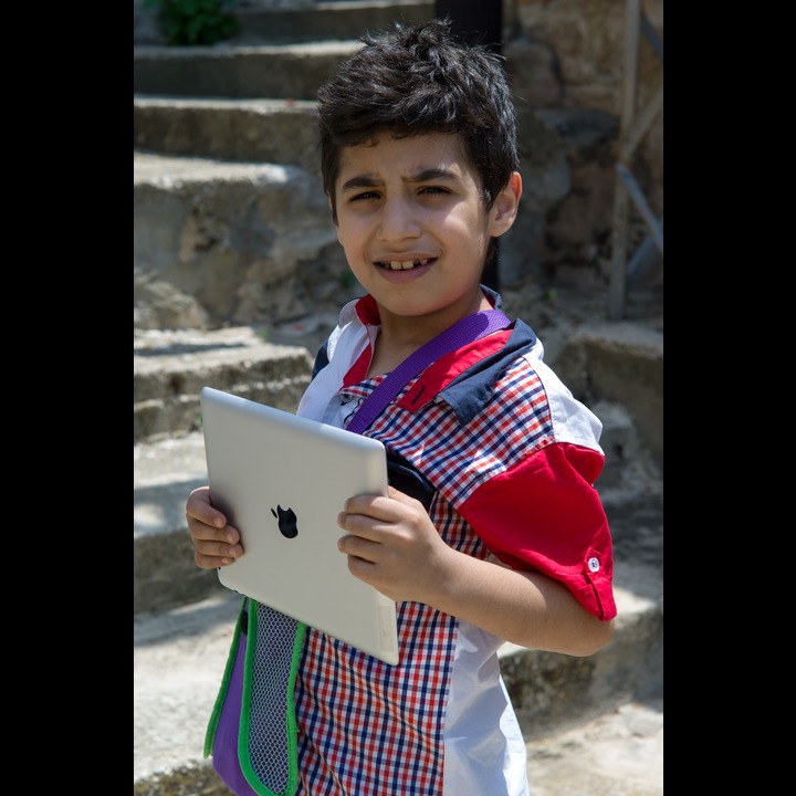 Young boy visiting in Abou Qamha on St. George's Day