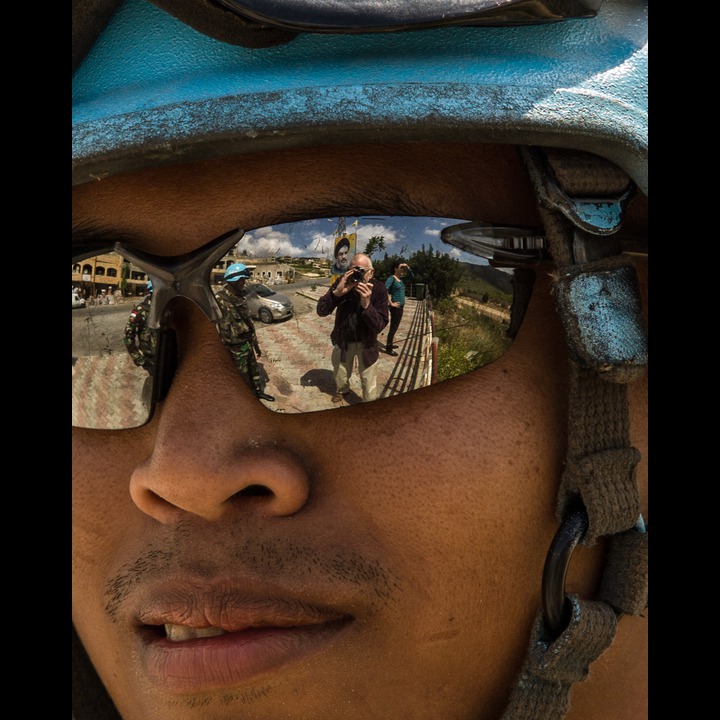 Self-portrait in the glasses of an Indonesian UNIFIL soldier at Aadaisse