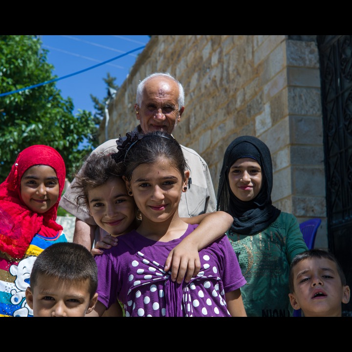'Izzat Birjaui and children at the Abou Dhar Al Ghifari shrine in Sarafand village