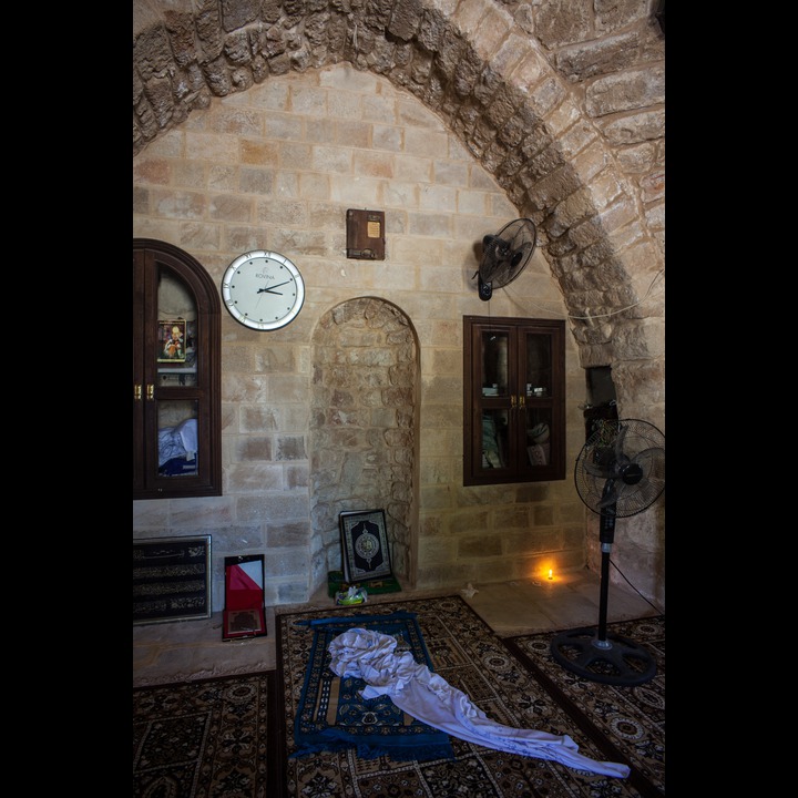 The mehrab and a lit candle in the Abou Dhar Al Ghifari shrine in Sarafand village