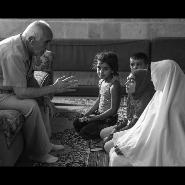 'Izzat Birjaui and children at the Abou Dhar Al Ghifari shrine in Sarafand village