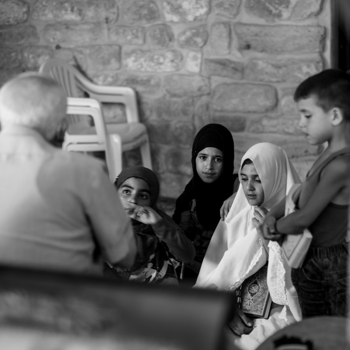 'Izzat Birjaui and children at the Abou Dhar Al Ghifari shrine in Sarafand village