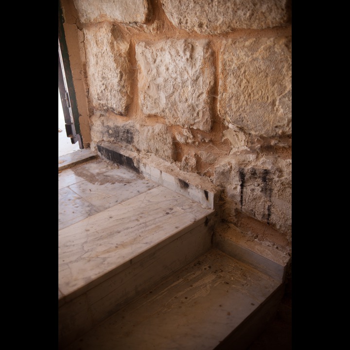 Candles are lit on either side of the stairs down to the bural chamber under the shrine of Nabi Haroun in Khartoum