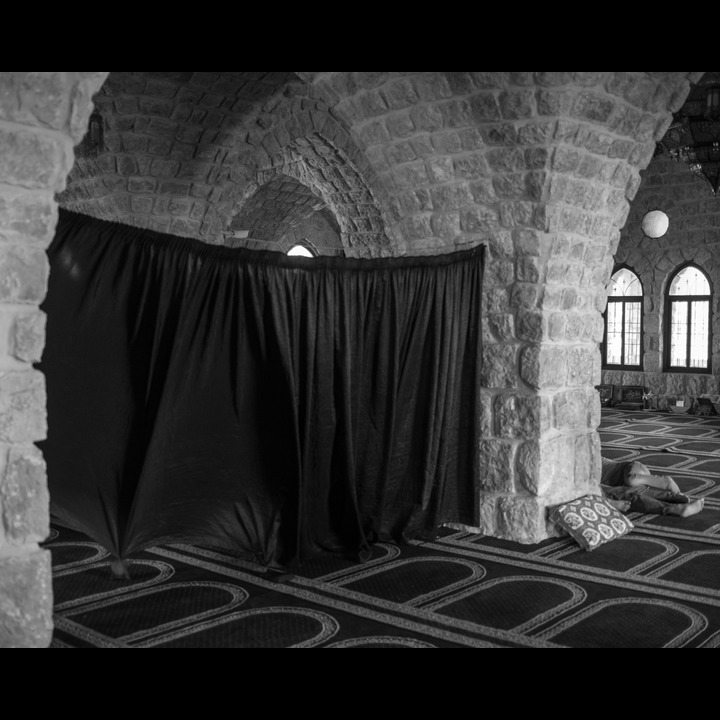 Nabi Sari at 'Adloun - the curtain separating men from women - a father and son resting behind the column