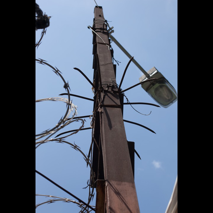 The utility pole at the top of the stairs on Rue Kennedy. The razor wire keeps people out of the AUB campus.