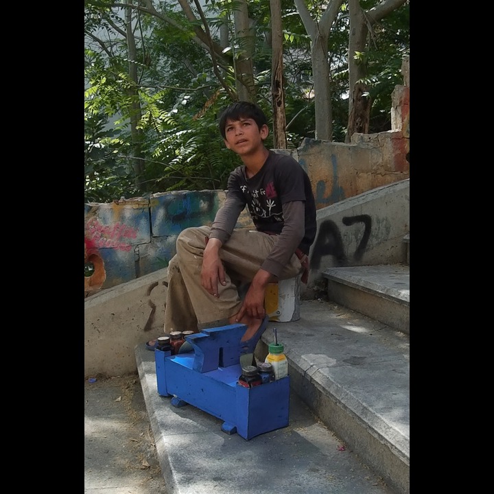 Syrian refugee shoe shine boy on the AUB stairs in AIn el Mraisseh