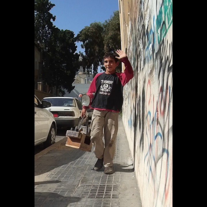 Syrian refugee shoe shine boy on the AUB stairs on Rue Kennedy