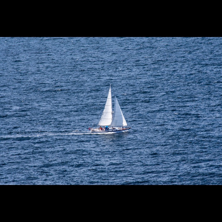 Danish sailboat passing Kullens Lighthouse
